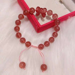 Strawberry crystal 9mm bracelet, with strawberry crystal carved bow, hand braided rope