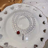 Natural white crystal 6mm two circle bracelet. With cinnabar cat paw p
