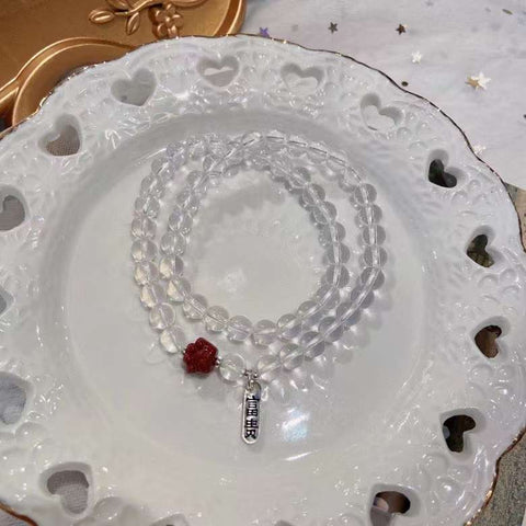 Natural white crystal 6mm two circle bracelet. With cinnabar cat paw p