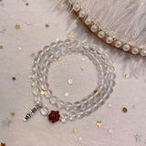 Natural white crystal 6mm two circle bracelet. With cinnabar cat paw p