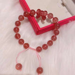 Strawberry crystal 9mm bracelet, with strawberry crystal carved bow, hand braided rope